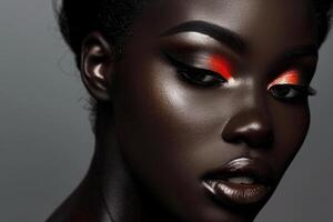 Beautiful black model posing with vivid red and silver eyeshadow makeup photo