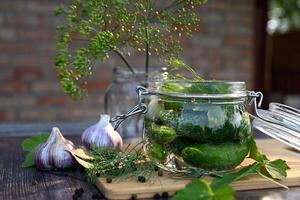 a set of ingredients for pickling cucumbers, pickled cucumbers, brine On a beautiful sunny morning photo