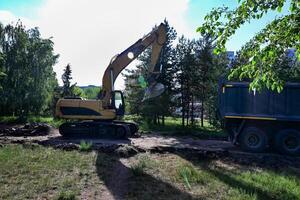 Excavator during earthmoving On a wonderful day with a positive attitude photo