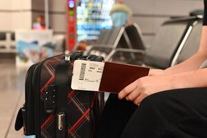 Closing a person with passports and boarding pass at the airport photo
