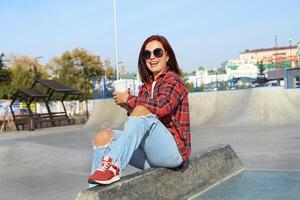 Woman with coffee on a bench, urban background photo