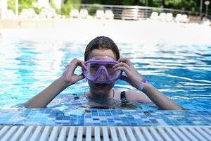 The photo captures a moment of fun and enjoyment as a girl swims in a pool, creating a cheerful and lively scene.