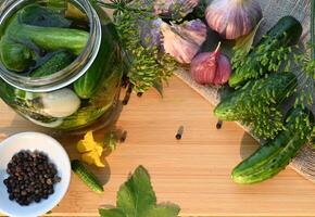 On a wonderful day with a positive attitude a set of ingredients for pickling cucumbers, pickled cucumbers, brine. photo