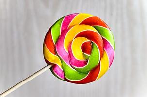 Multicolored lollipop on a light background. photo