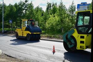 Large view on the road rollers working on the new road construction site on a beautiful sunny morning photo