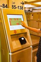 luggage storage at the train station, contactless payment using the terminal on a wonderful day photo