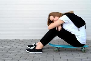 The image depicts a person with a skateboard resting on their shoulder, a pose that suggests movement photo