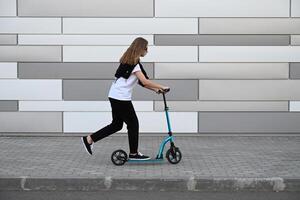 The image captures the motion of a person riding a scooter, highlighting a sense of activity and movement photo