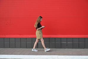 Portrait of a young student reading a message on a mobile phone photo