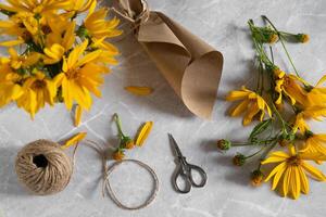 An image of a blank card surrounded by bright yellow flowers suggests a message or note to be written, hinting at a personal connection or greeting photo