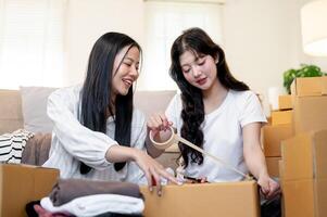Two beautiful Asian women are talking while preparing to relocate or move house. photo