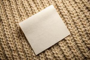 Close-up of a beige knitted fabric with a blank tag for product labeling for business photo
