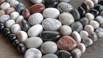 Assorted polished stones for business use like decoration or product presentation on a wood surface photo