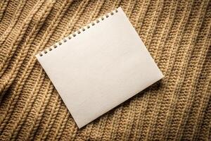 Notebook blank page on knitted texture background for business presentations or templates photo