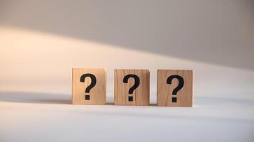 Three wooden blocks with question marks for business solutions and decision making photo