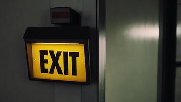 Illuminated Exit Sign with a Yellow Background for Business Applications and Safety photo