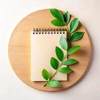 Minimalist Notepad and Green Leaves on Wooden Plate for Business Use in Natural Style photo