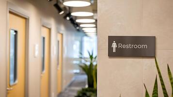 Business interior of a hallway with doors and a restroom sign, suitable for corporate use photo
