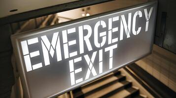 Illuminated emergency exit sign for office safety and emergency preparedness at a workplace photo