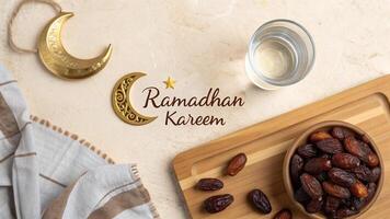 Ramadan Kareem themed image featuring dates, water, and decorative moon elements for business use photo