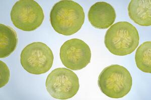 Armenian cucumber slices texture isolated on white background photo