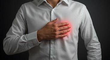Man in white shirt with chest pain with isolated background photo