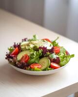 Deliciously Fresh Salad with Avocado, Cucumber, and Tomatoes on a Light Table photo