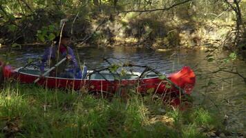 Cowboy in a canoe floats on the river in the forest. Historical reconstruction of life in the wild west of America. 4K video