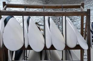 Surfboards in the Rack Along the Water photo