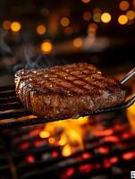 Perfectly grilled steak with charred marks sizzling over an open flame, lifted by tongs with a warm, smoky ambiance in the background. photo