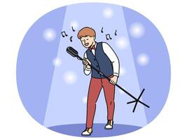 Talented boy singer holds professional microphone on tripod standing in light of spotlight vector