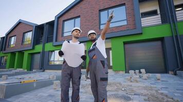 Builders Reviewing Plans at Construction Site video
