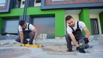 Two Diverse Workers Installing Paving Stones video