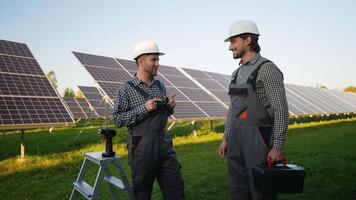 Workers Discussing Solar Panel Installation with Tools video
