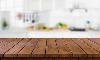Wooden table top in front of a kitchen photo