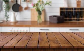 Wooden countertop in kitchen with flowers and vases photo