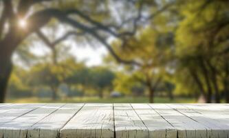 Empty wooden table in the park with trees and sun photo