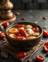 A bowl of soup with tomatoes and other ingredients photo