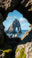 A view of the ocean from inside a rock tunnel photo