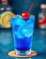 Refreshing blue cocktail garnished with cherry and lemon on wooden coaster at a bar photo