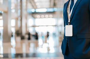 A man in a suit and tie standing in a lobby photo