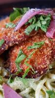 Crispy chicken served over creamy pasta video
