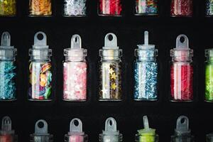 A display of different colored and shaped nail polish photo