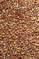 Close-Up View of Buckwheat Groats, vertical- Ideal for Nutrition Articles, Culinary Blogs, and Health-Related Marketing Materials photo