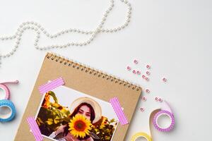 Crafting memories with a sunflower photo and decorative elements in a creative workspace