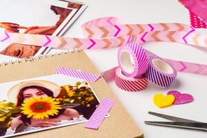 Crafting a vibrant scrapbook with photos, washi tape, and colorful decorations in a cheerful setting photo