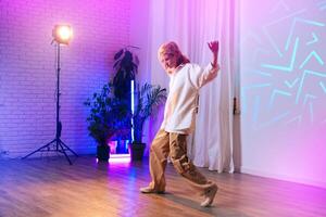 Dancer showcasing dynamic movement in colorful studio with soft lighting and modern decor photo