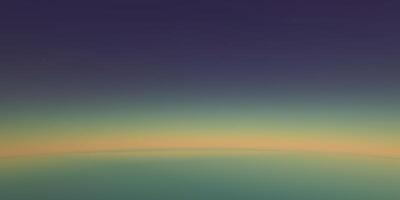 Abstract earth horizon gradient at twilight with deep blue and golden hues photo