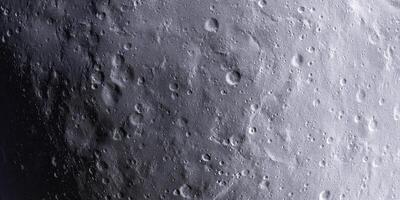 Detailed lunar surface with craters and shadows captured in monochrome view photo