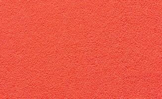 Bright red textured carpet close up with soft fiber pattern and detailed abstract design. photo